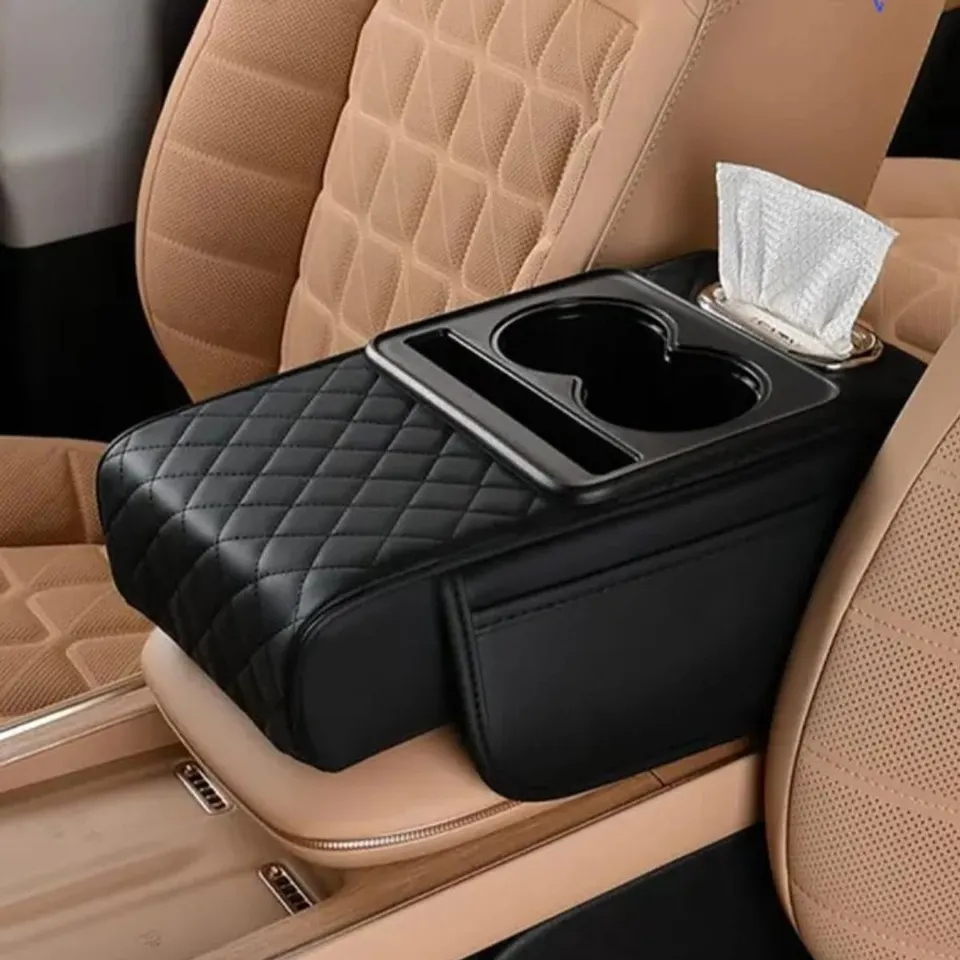 Black quilted car armrest box on a centre console, with two cup holders, a phone slot and tissues in the holder